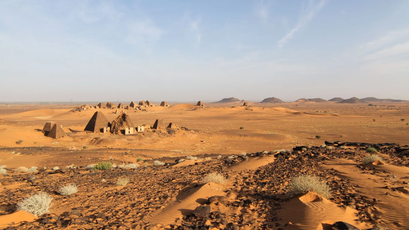 Explore the ancient pyramids of Meroë against the vast desert landscape in Sudan.