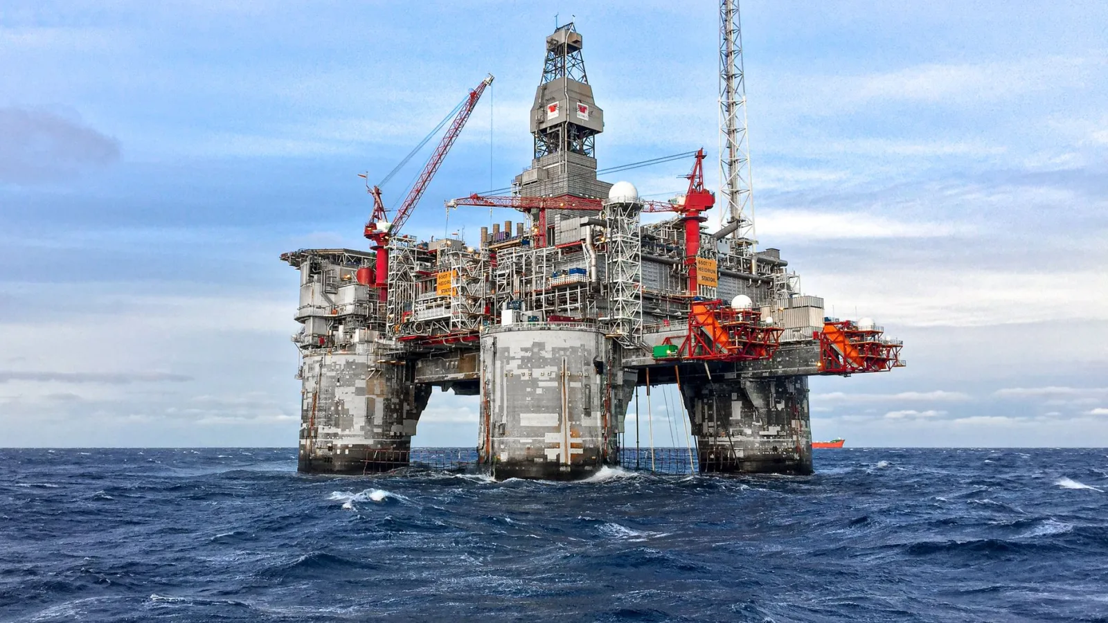 An offshore oil platform in Norway's North Sea under a clear blue sky.