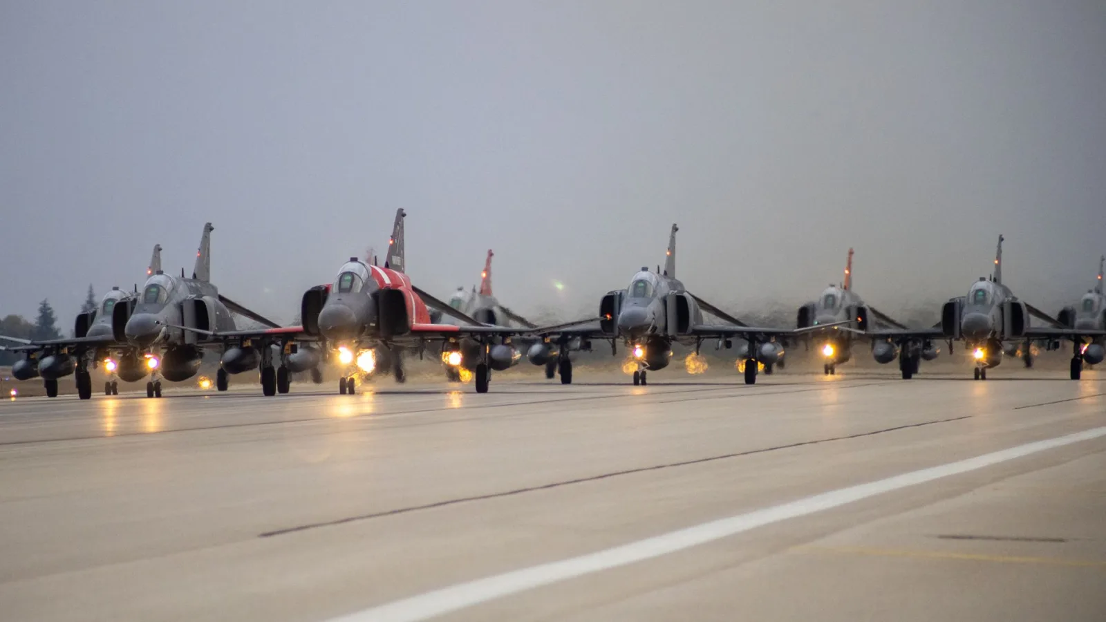 Fighter jets lined up on a runway in Eskişehir, Türkiye for a military operation.