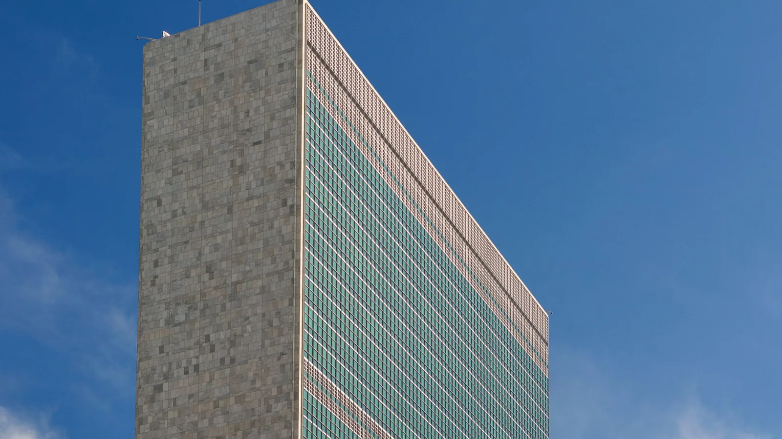 The iconic United Nations building in NYC captured against a vibrant blue sky, showcasing its modern architecture.